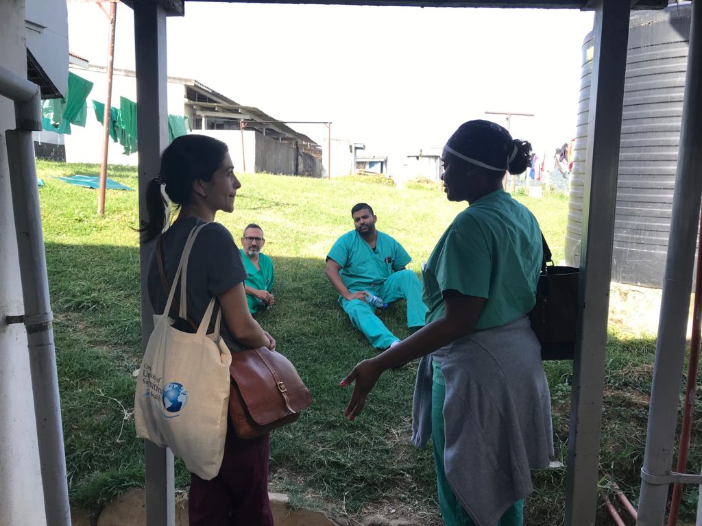 Doctors and medical staff talk outside
