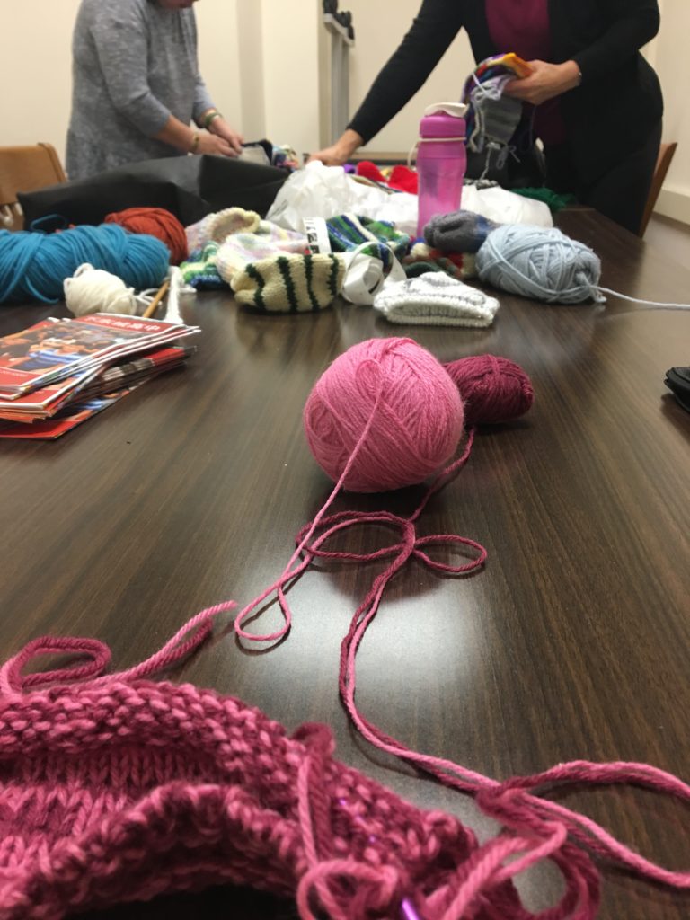 Captured above is one of the weekly meetings of The Chatham Square Library Knit for a Cause Knitting Group. Several dedicated members knit up to one hat per day for Saving Mothers. 